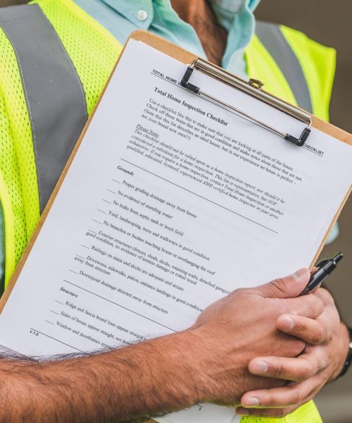 Code Enforcer of Summerset holding total home inspection checklist