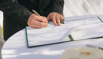 Person signing documents for their licensing form